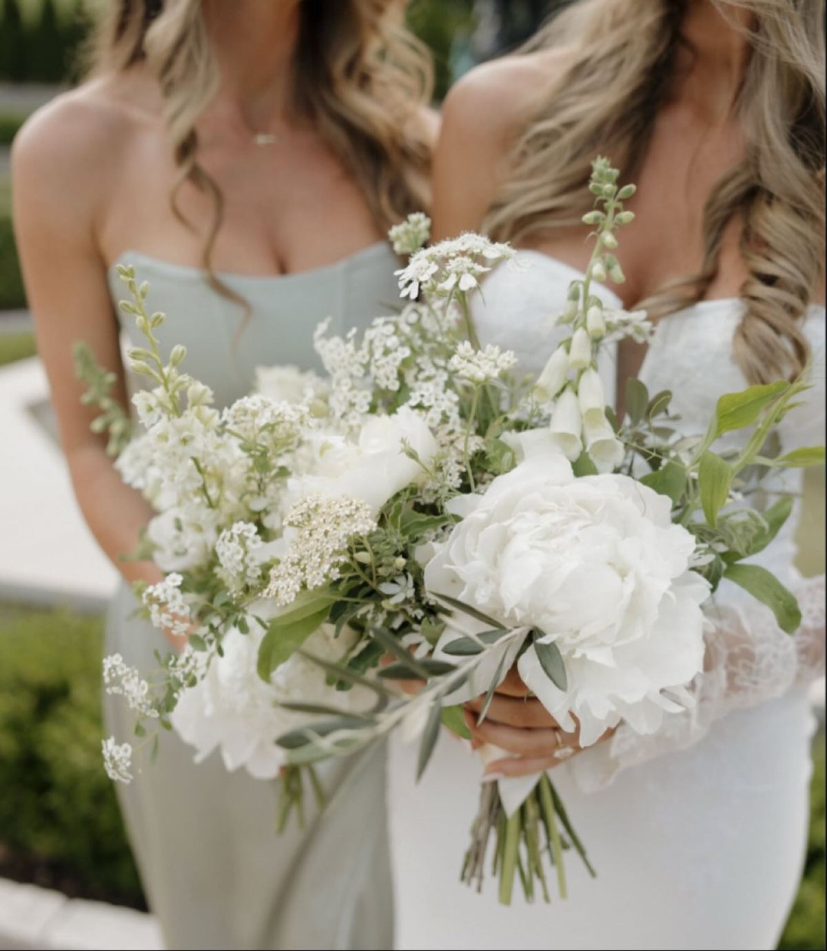 A bridal bouquet of white peonies and garden greenery
